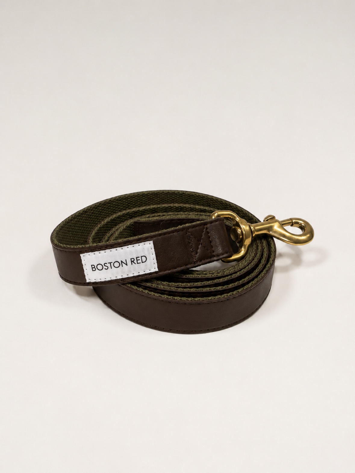 Boston Red Founders Leash coiled on its own — brown leather and olive canvas with solid brass snap and white Boston Red label